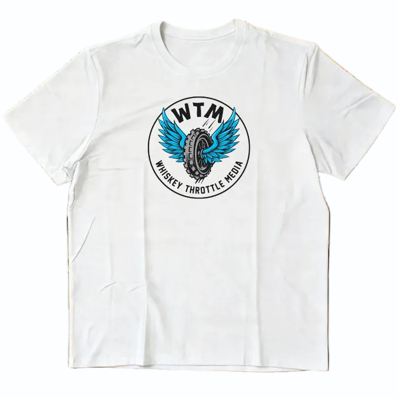  white short-sleeve crewneck t-shirt with a circular graphic on the chest featuring a blue winged tire and the text 'WTM' and 'WHISKEY THROTTLE MEDIA'. The t-shirt is laid flat