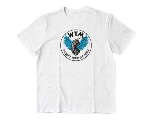  white short-sleeve crewneck t-shirt with a circular graphic on the chest featuring a blue winged tire and the text 'WTM' and 'WHISKEY THROTTLE MEDIA'. The t-shirt is laid flat
