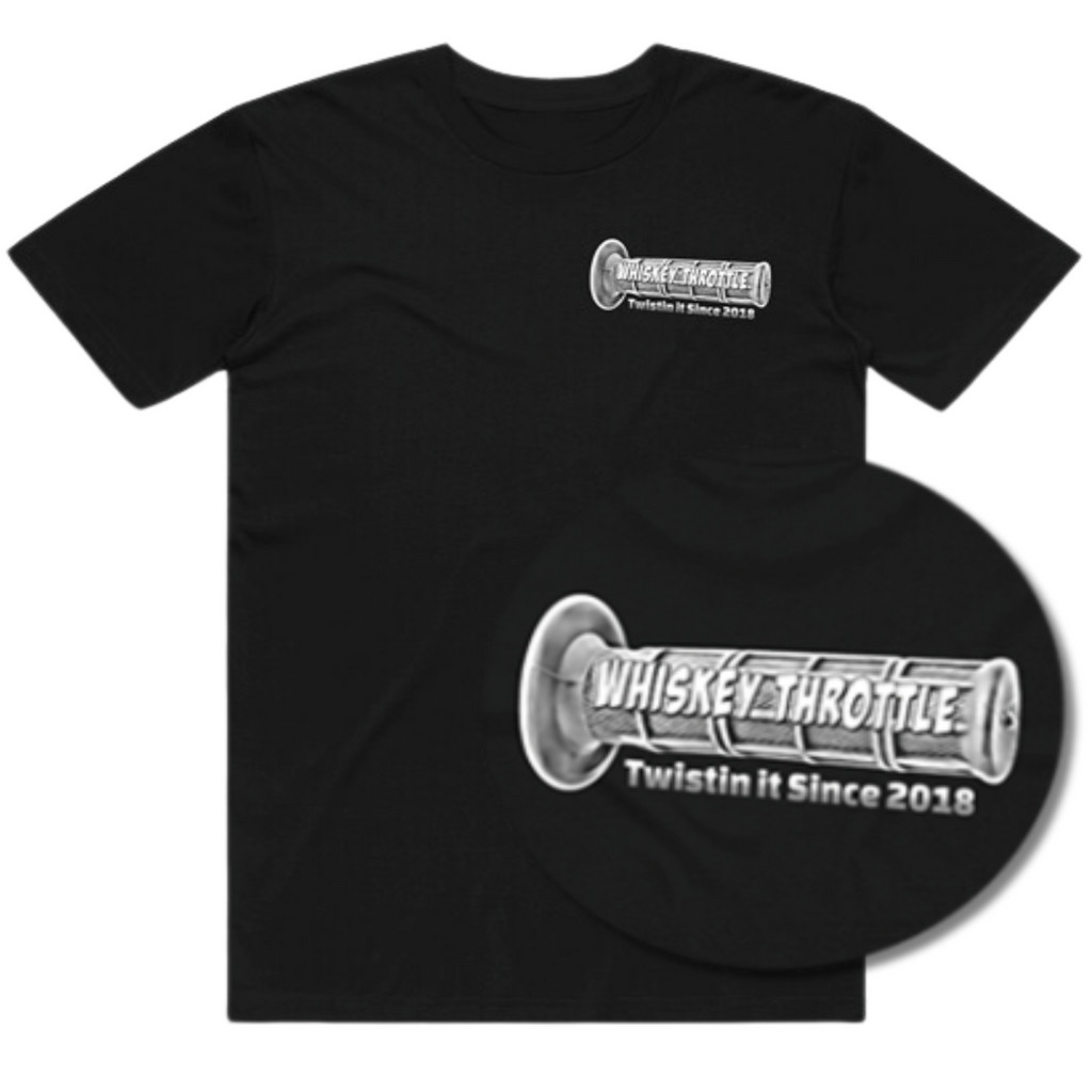 Black t-shirt featuring a small logo on the chest and a larger, circular graphic with the text "Whiskey Throttle" and an illustrated dirt bike grip, established in 2018.