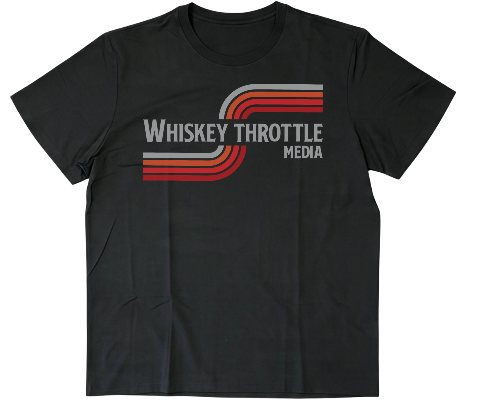 A black short-sleeve crewneck t-shirt featuring a retro-style graphic on the chest with the text 'WHISKEY THROTTLE MEDIA' in white and red/orange striped accents, displayed on a solid white background.